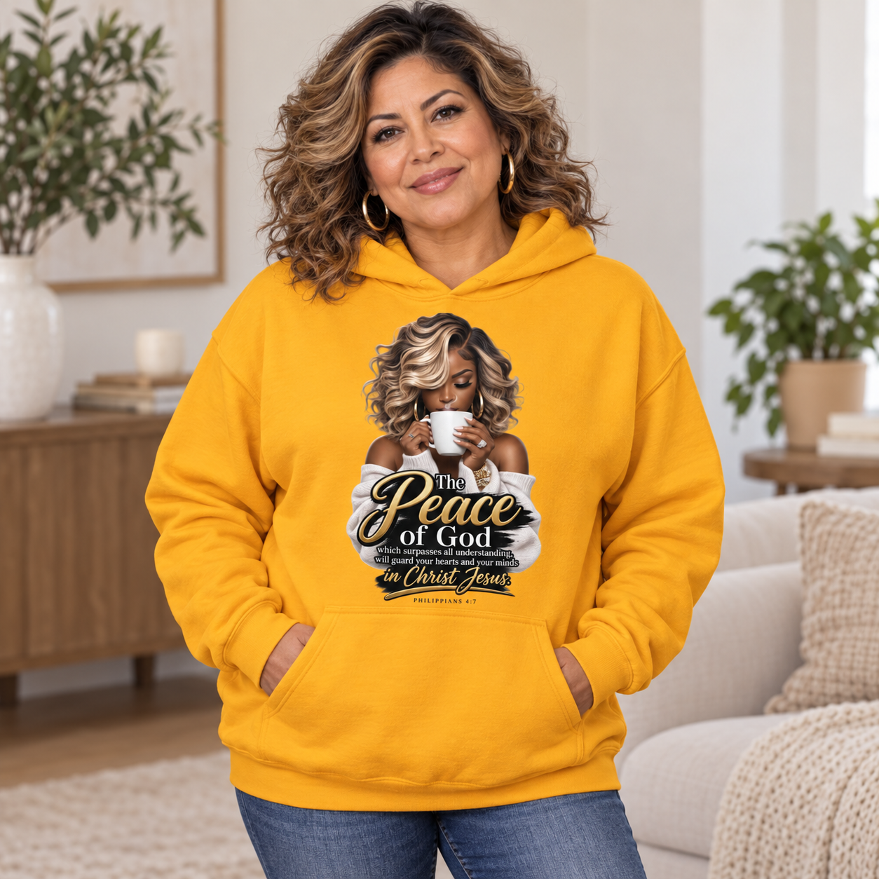 Latina woman wearing gold Peace of God Christian hoodie